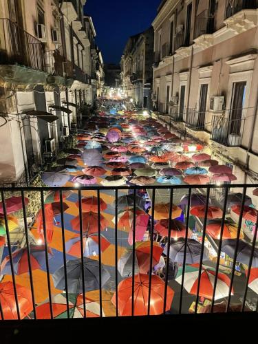 a street filled with lots of colorful umbrellas at Principe del Pardo in Catania