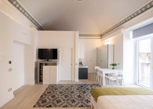 a bedroom with a bed and a dining room with a table at Principe del Pardo in Catania