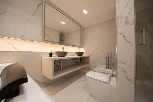 a bathroom with a sink and a toilet and a mirror at Principe del Pardo in Catania