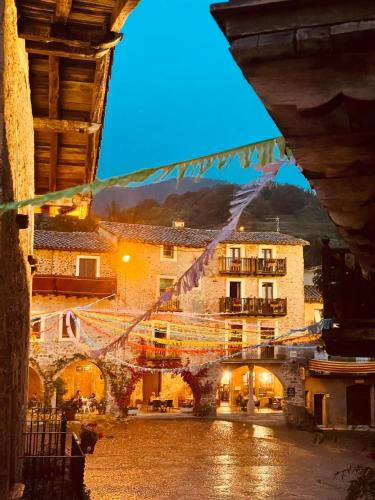 a view of a town with a bridge and buildings at Hotel Cal Sastre in Santa Pau