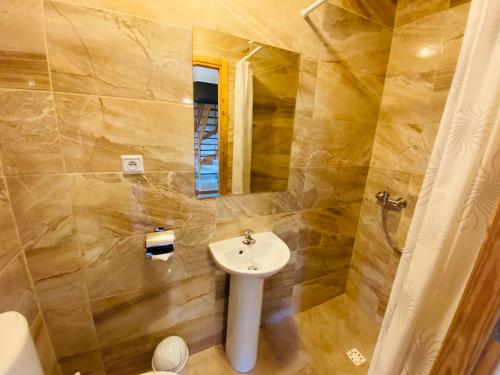a bathroom with a sink and a mirror at Caloroczne Domki Aleksander in Kacwin