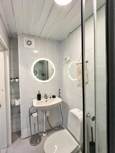 a bathroom with a sink and a toilet and a mirror at Sunny Nest 1 in Vaasa