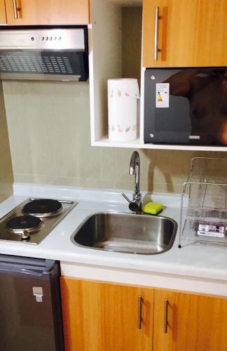 a kitchen with a sink and a microwave at Cabañas Pucón - 3 tipos para 2 o 4 personas in Pucón