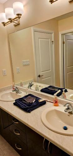 a bathroom with two sinks and a large mirror at Luxury 5 Bed Retreat for 12 with Gourmet Kitchen in Paris