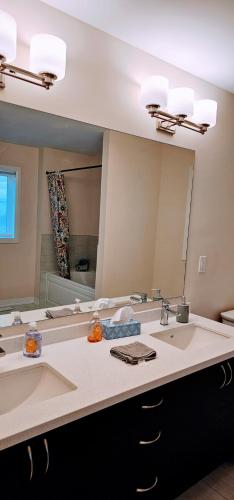 a bathroom with two sinks and a large mirror at Luxury 5 Bed Retreat for 12 with Gourmet Kitchen in Paris