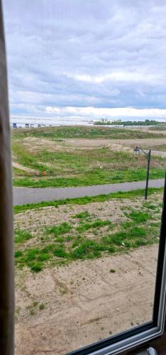 a view from a window of a field with a road at Luxury 5 Bed Retreat for 12 with Gourmet Kitchen in Paris