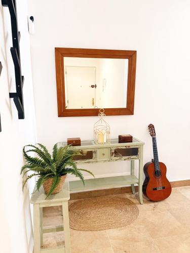 a dressing table with a mirror and a guitar at I Loft 9 I Centro de Alcala Sevilla in Alcalá de Guadaira