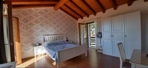 a bedroom with a bed and a table and a window at Il Sogno di kovalsky - B&B Relax & Nature in Polcenigo