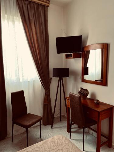 a room with a desk and a television and a mirror at Bella Vista in Balíon