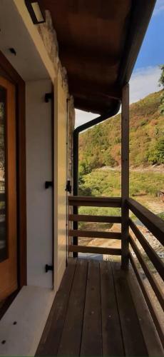 a door to a porch with a view of a field at Il Sogno di kovalsky - B&B Relax & Nature in Polcenigo