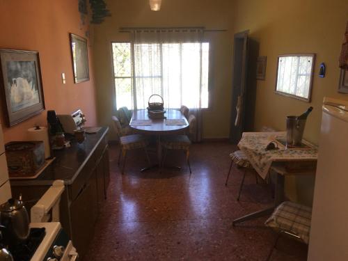 a kitchen with a table and a dining room at TERRAZAS DEL SUR in Ezpeleta
