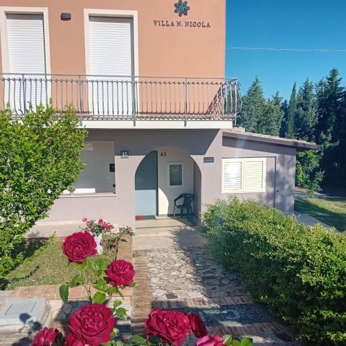 a house with red roses in front of it at Villa Nonno Nicola in Montenero di Bisaccia