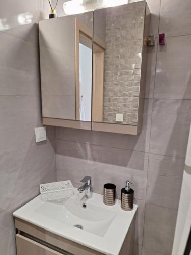 a bathroom with a sink and a mirror at EFReMIAS PLACE in Rhodes Town