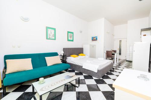 a room with a bed and a couch and a table at Peaceful OAZA in Stara Novalja