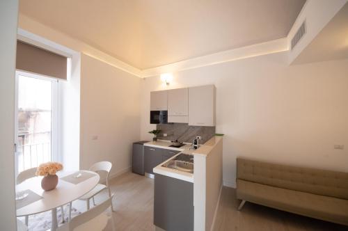 a kitchen and living room with a table and a dining room at Principe del Pardo in Catania