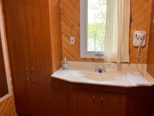 a bathroom with a sink and a window at Camping Chalets Lac St-Augustin in Quebec City