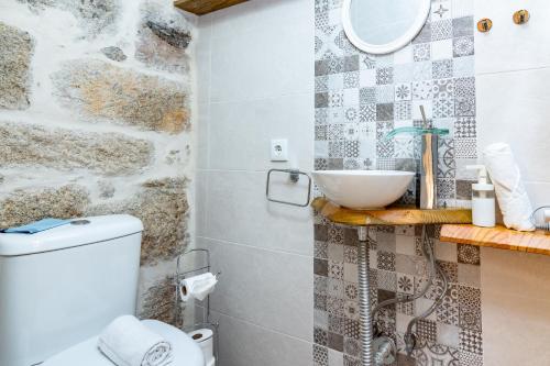 a bathroom with a sink and a toilet at Douro View House Ribeira in Porto