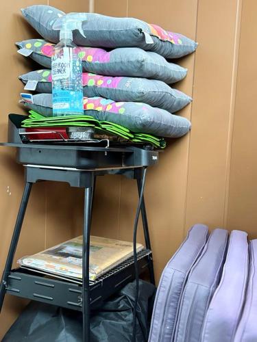 a stack of pillows on a table next to a wall at Gîte Le Sambre in Thuin