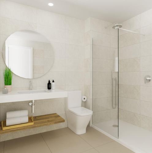 a bathroom with a toilet and a sink and a shower at Valencia Living Suites in Picanya