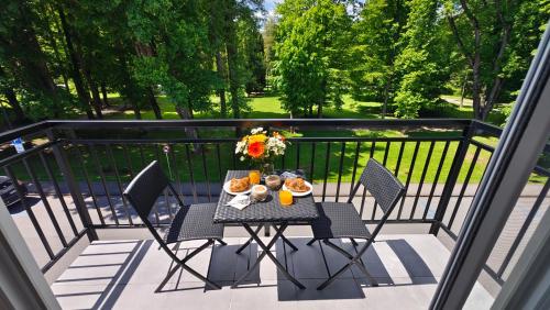 a table with food and flowers on a balcony at Apartmán Verdi in Turčianske Teplice