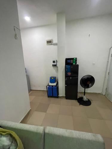 a living room with a couch and a black refrigerator at 1 bedroom apartment in Awoyaya