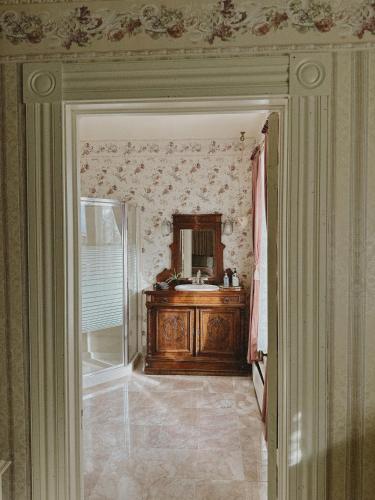 a bathroom with a sink and a mirror at Adams Pragge House - Victorian Bed & Breakfast in Port Townsend