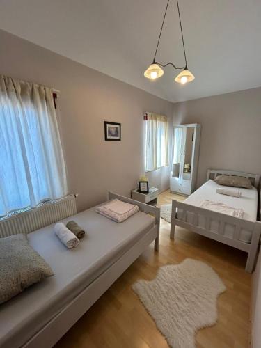 a bedroom with two beds and a large window at Apartmani Lucija in Zadar