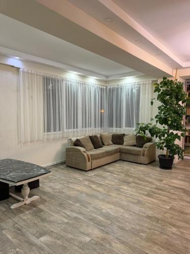a large living room with a couch and a table at Three-bedroom apartment "Nikala" in Tbilisi City