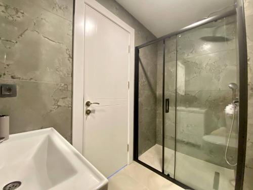 a bathroom with a shower and a white sink at Boutique 16 - Alanya Experience in Alanya