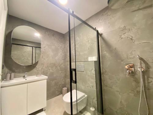 a bathroom with a shower and a toilet and a sink at Boutique 16 - Alanya Experience in Alanya