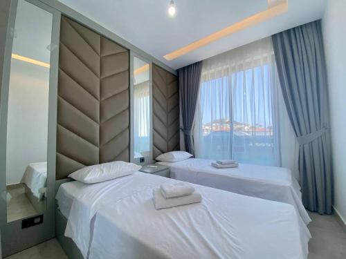 a hotel room with two beds and a window at Boutique 16 - Alanya Experience in Alanya
