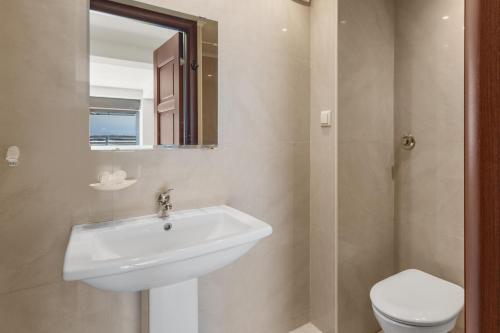 a bathroom with a sink and a toilet at Villa Rea Chania in Argoulidhés