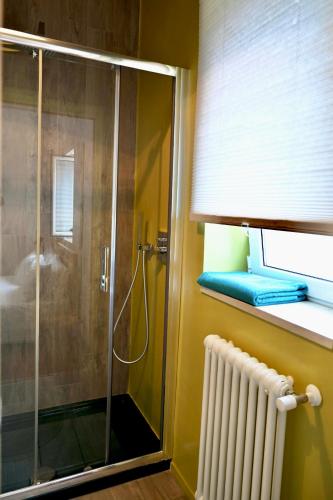 a shower with a glass door in a bathroom at Matinee Rooms in Mattinata