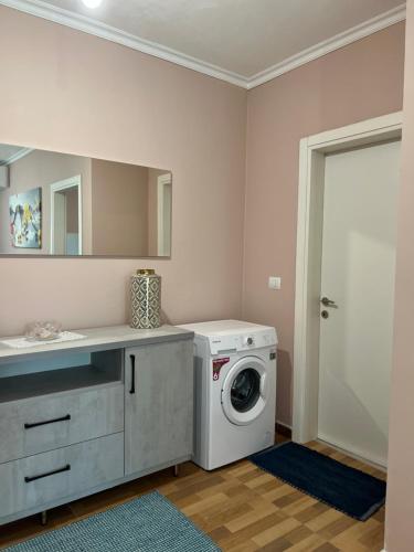 a laundry room with a washing machine and a sink at Durres Relax Holiday Home in Qerret