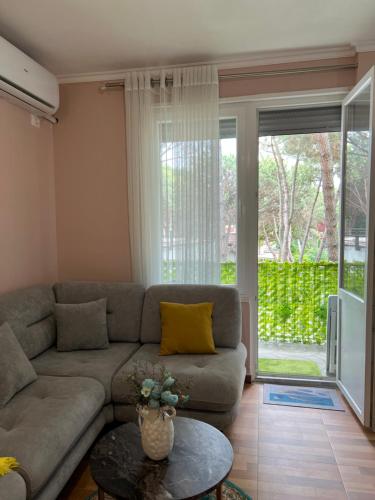 a living room with a couch and a table at Durres Relax Holiday Home in Qerret