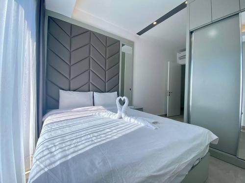 a bedroom with a white bed with a swan on it at Boutique 16 - Alanya Experience in Alanya