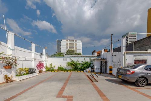 a car parked in a parking lot next to a building at Hotel Don Fermín in Barranquilla