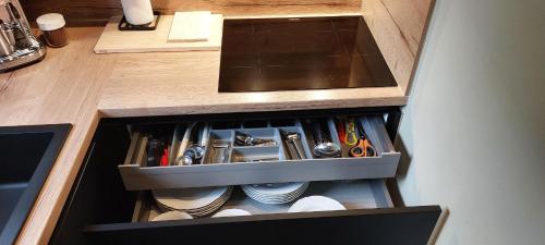 a drawer in a kitchen withrenches and utensils at Maison Aunais in Mormont-La-Grande