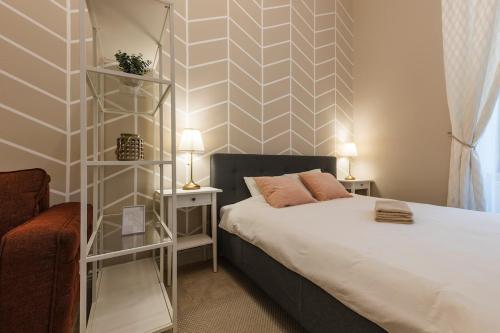 a bedroom with a bed and two night stands at #Comfy Apartment in Old Town in Timişoara