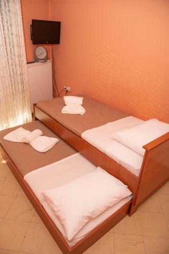 two beds in a room with towels on them at Centre Apartment in Alexandroupoli