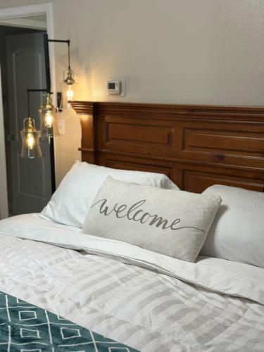 a bed with a welcome pillow on top of it at Comfort and Cozy in Fairbanks !! in Fairbanks