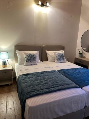 a bedroom with two beds with blue and white pillows at Sami Loft in Sami