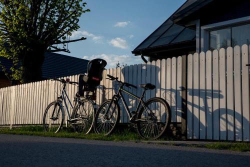 two bikes are parked next to a fence at Stara Stolarnia Noclegi in Jędrzejówka