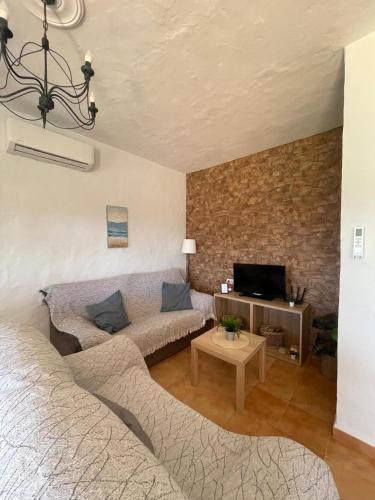 a living room with a bed and a couch at casa lucia in Cádiz