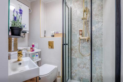 a bathroom with a shower and a toilet and a sink at Seafront Apartment Balcony Panoramic View in Kaštela