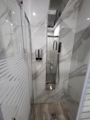 a shower with a glass door in a bathroom at Diamond Piraeus Port in Piraeus