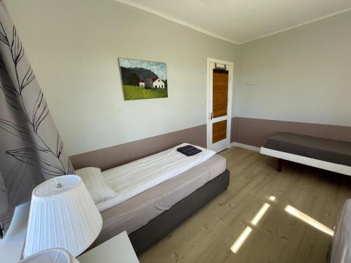 a small bedroom with a bed and a window at Lækjarhus Farm Holidays in Borgarhöfn