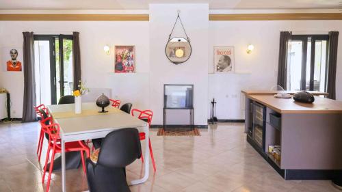 a living room with a table and chairs and a tv at Casa Nova Maison d'hôtes in Sagone