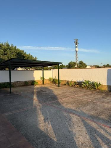 a shelter in a parking lot next to a wall at casa lucia in Cádiz