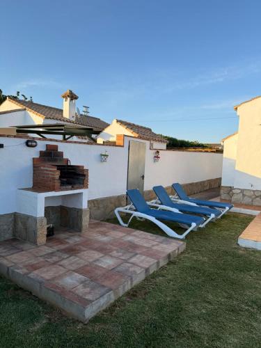 a patio with two lounge chairs and a fireplace at casa lucia in Cádiz